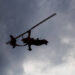 A modern, closed-cabin, pusher-propeller autogyro in flight
